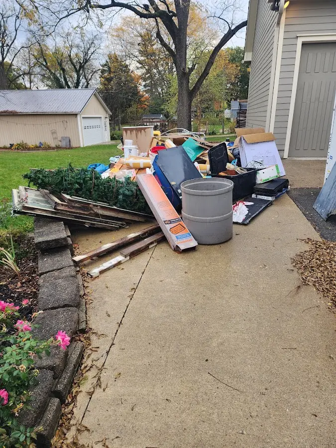 Dumpster being loaded with debris for 12 Yard Dumpster Rental in Oxford